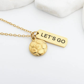 Gold necklace with soccer ball pendant and 'LET'S GO' tag on a white background