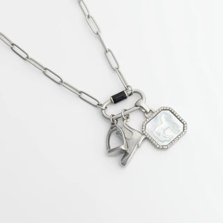 Necklace with heart and horse shoe charms on a white background