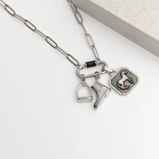 Silver necklace with horse-related charms on a white background