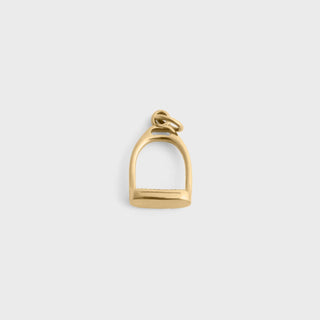 Gold stirrup charm on a white background