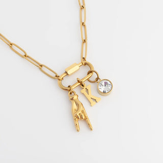 Gold necklace with charms on a white background