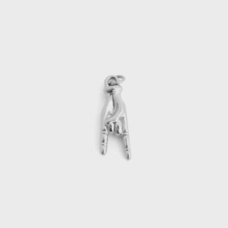 Silver charm shaped like a hand making a peace sign on a white background