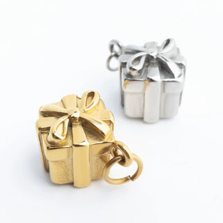 Gold and silver gift box-shaped charms on a white background