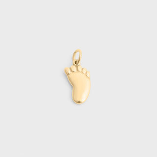 Gold baby foot-shaped charm on a light gray background