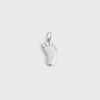 Silver baby foot charm on a white background