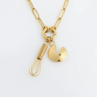 Gold necklace with a unique pendant on a white background