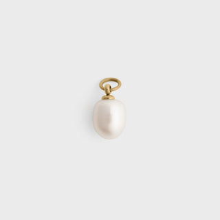 Pearl pendant with gold chain on a light gray background