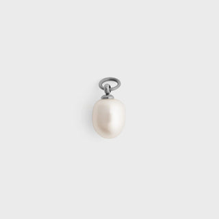 Pearl charm with a silver jump ring on a white background
