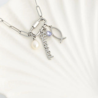 Silver necklace with charms on a white background