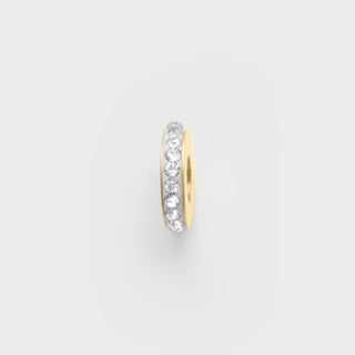 Gold spacer bead with embedded cz stones on a light gray background