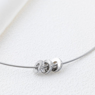 Silver necklace with spacer beads on a white background