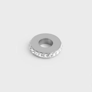Silver spacer beads on a light gray background