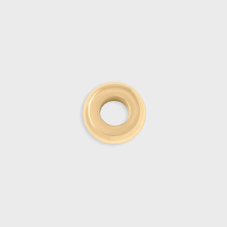 Gold spacer bead on a light gray background