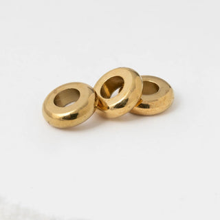 Three spacer beads stacked on a white background