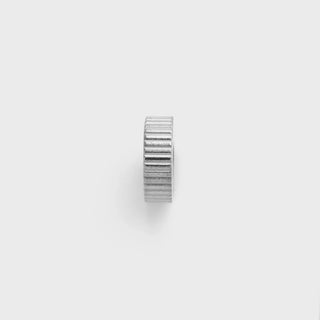 Silver fluted spacer bead on a light gray background
