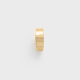 Gold spacer bead on a light gray background