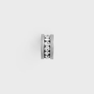 Silver spacer bead with embedded crystals on a light gray background