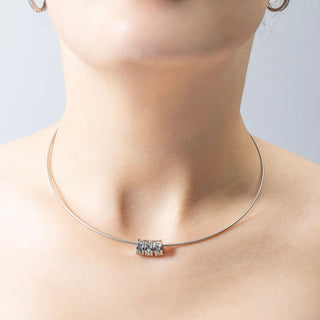 Necklace with a spacer beads on a neck against a neutral background