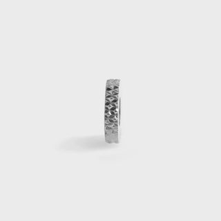 Silver textured spacer bead on a light gray background
