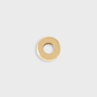 Gold spacer bead on a light gray background