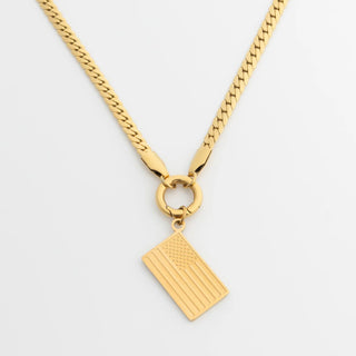 Gold necklace with a flag pendant on a light gray background