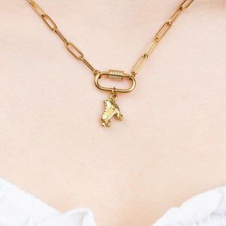 Gold necklace with a roller skate charm