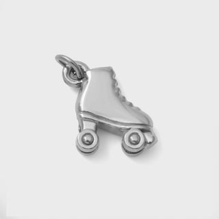 Silver roller skate charm on a white background