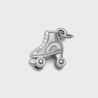 Silver roller skate charm on a light gray background