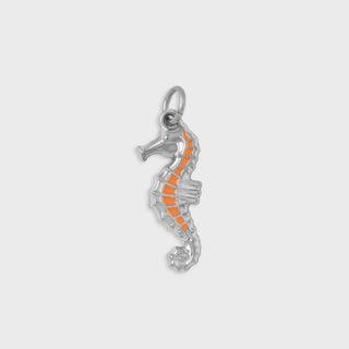 Silver seahorse pendant with orange accents on a light gray background