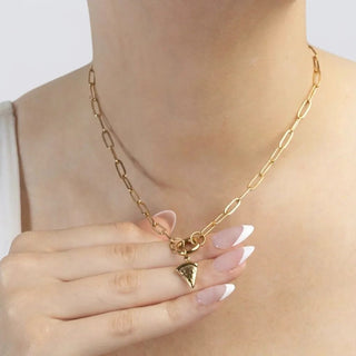 Gold chain necklace with a pizza pendant on a plain background