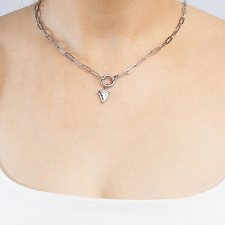 Silver necklace with a pizza shaped pendant on a plain background