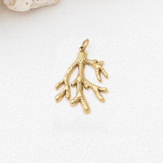 Gold coral pendant on a white background
