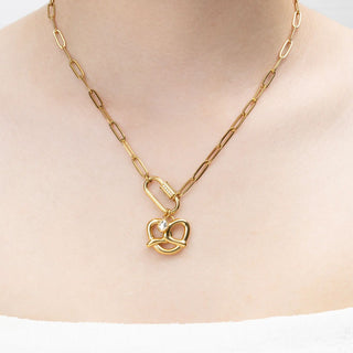 Gold necklace with a pretzel shaped pendant