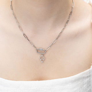 Silver chain necklace with a ice cream pendant on a person wearing a white top.