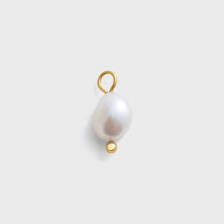 Pearl pendant with gold accents on a light gray background