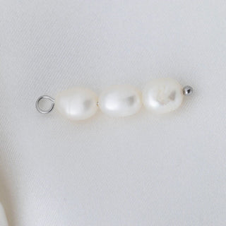 Three pearls on a white background