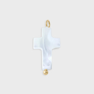 White cross-shaped pendant with gold accents on a light gray background