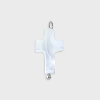 Cross-shaped pendant with a white stone on a light gray background