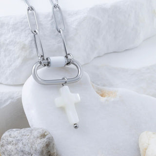 Necklace with a white pendant on a textured white background