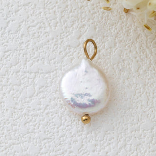 Pearl pendant with gold accent on a textured white background