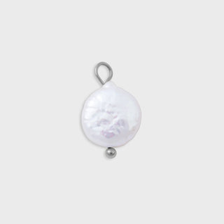 Pearl pendant with silver ring on a light gray background