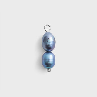 Black pearl earring on a light gray background