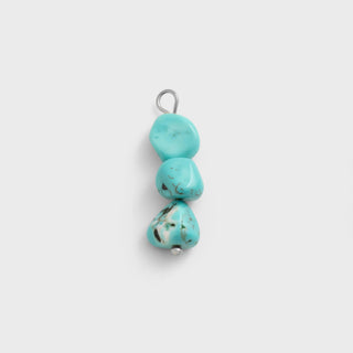 Turquoise stone pendant on a white background