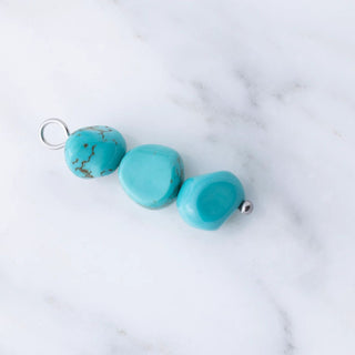 Turquoise beads on a marble background