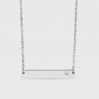 Silver bar necklace with a small diamond on a light gray background