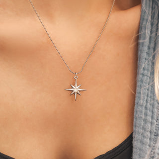Star-shaped pendant necklace on a person's neck